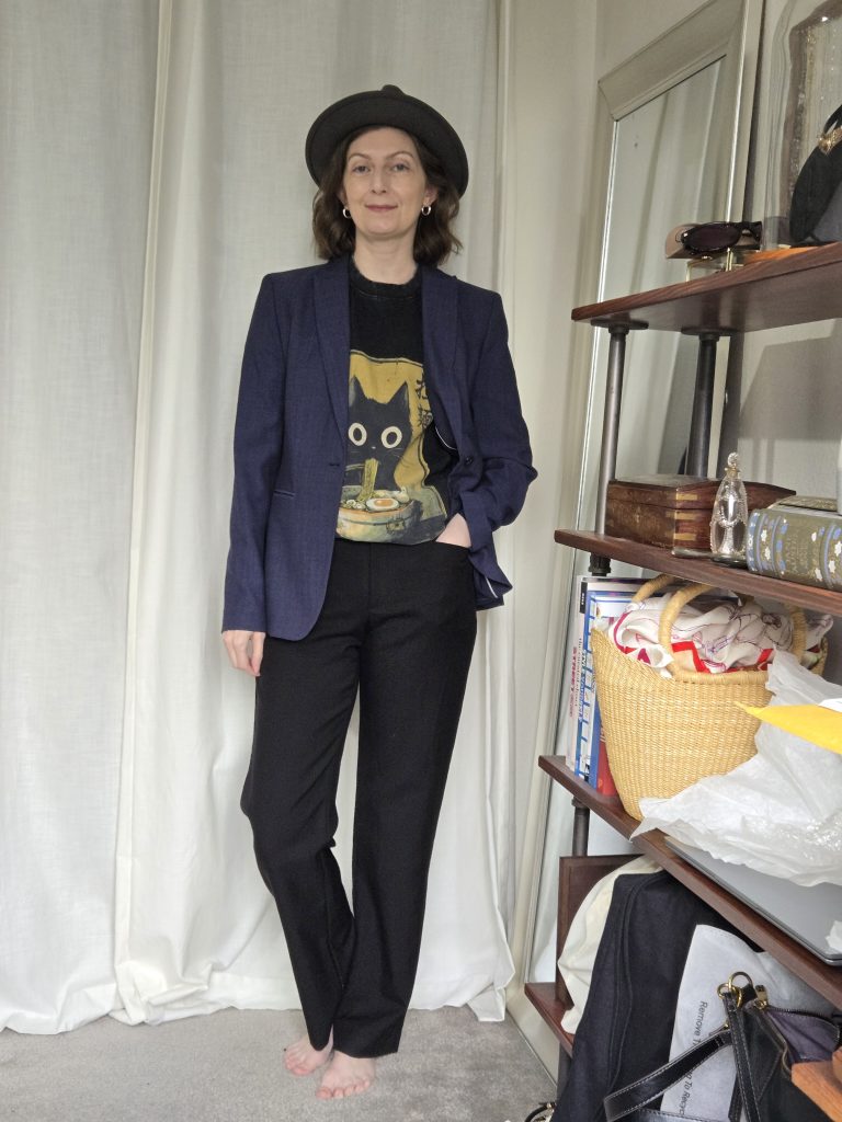 graphic tee, black trousers, navy blazer with fedora