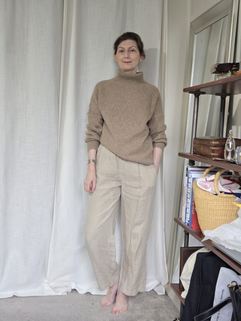 taupe turtleneck sweater with cream pants